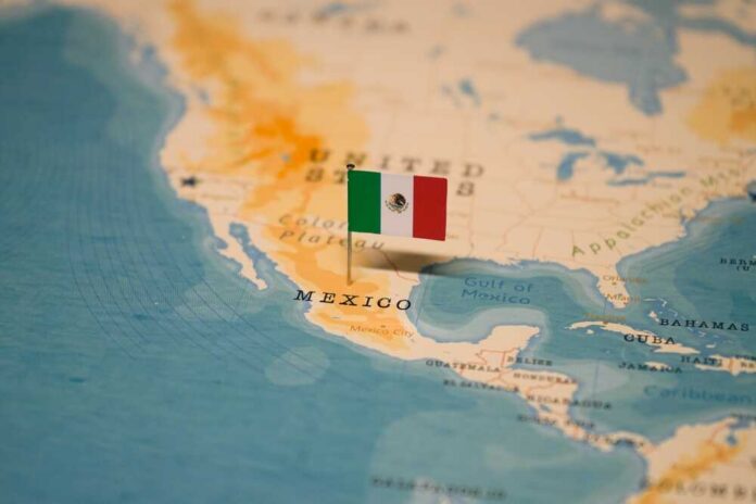 Map highlighting Mexico with a small flag