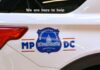 Side view of a Metropolitan Police vehicle with a help message