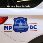 Side view of a Metropolitan Police vehicle with a help message