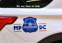 Side view of a Metropolitan Police vehicle with a help message