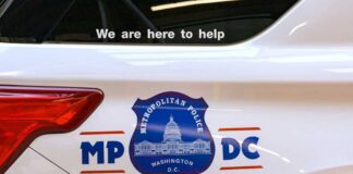 Side view of a Metropolitan Police vehicle with a help message