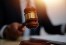 Judge’s Bold Move Divides: Cameras Stay In! A gavel being struck on a desk in a courtroom setting