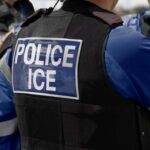 Immigration Detention Protest Sparks Viral Confusion Close-up of a police officer's vest with 'POLICE ICE' insignia