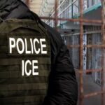 Police officer in tactical gear standing in a detention center