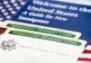 U.S. permanent resident cards with immigration guide and flag