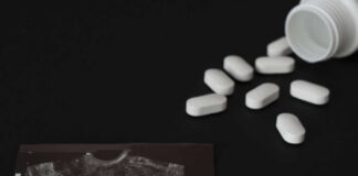 Ultrasound printout beside scattered white pills and an open bottle