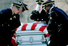 Honor Guard carrying a flag-draped casket
