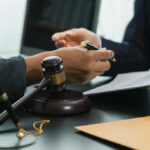 Court Slams DOJ’s Medical Records Grab Hands of professionals discussing documents beside a judge's gavel