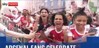 Thousands of Arsenal fans line the streets of North London for Premier League trophy parade