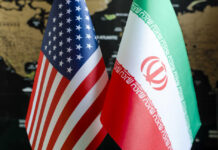 U.S. Control Questioned In Swiss Showdown Flags of the United States and Iran displayed together