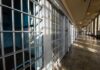 Hostile Regimes Weaponize Americans—Who’s Next? Interior view of a prison corridor with jail cells and sunlight streaming through windows