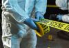 Horrific Congo Killings — Silence Reigns forensic investigators unrolling yellow barrier tape at night