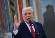 Voter ID Ultimatum Stalls Intel Takeover A man speaking passionately into a microphone with his hand raised
