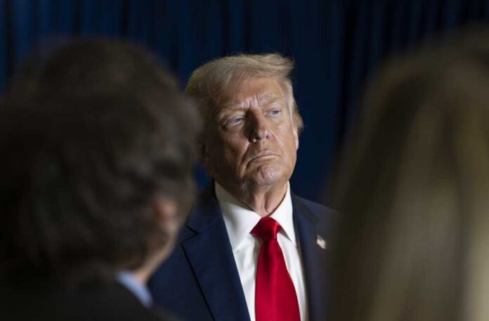 New,York,City,,New,York,,Usa,,September,23,,2025: A serious-looking man in a suit with a red tie, surrounded by blurred figures