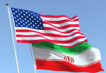 Trump Says Yes. Iran Says Wait. American and Iranian flags waving in the sky.