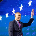Democrats Clash Over Florida House Race Person waving in front of a starry blue background
