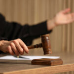 A Court Ruling Raises Serious Border Questions Judge's hand striking a wooden gavel on a block