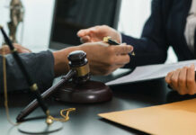New Evidence Changes The Charlie Kirk Debate Hands of professionals discussing documents beside a judge's gavel