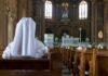 The Assisted-Dying Lawsuit Testing Religious Freedom Person in white habit seated in a church pew facing the altar