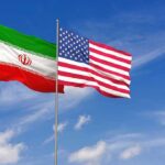 Iran’s Strategic Message Targets Washington Iran and United States flags waving on flagpoles