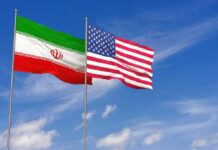 Iran’s Strategic Message Targets Washington Iran and United States flags waving on flagpoles