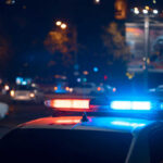 Arrests Sweep Stops UFC Mass-Casualty Plot Police car with flashing blue and red lights in a city at night