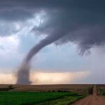 Nature Pulled Off An Unbelievable Double Take Tornado touching down over open farmland under dark storm clouds