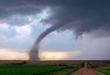 Nature Pulled Off An Unbelievable Double Take Tornado touching down over open farmland under dark storm clouds