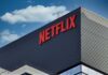 Netflix’s Latest Label Sparks Fresh Backlash Close-up of the Netflix logo on a modern building against a blue sky