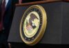 DOJ Reinterprets Disability Law, Sparking New Debate Department of Justice seal on a podium