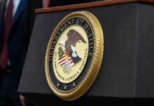DOJ Reinterprets Disability Law, Sparking New Debate Department of Justice seal on a podium