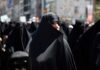 Women in black attire participating in a protest