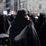 One Ceremony Revealed A Bigger Strategy Women in black attire participating in a protest