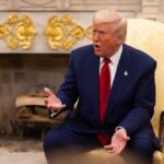 Networks Split Over Trump’s Primetime Election Address A man in a blue suit and red tie gesturing during a discussion in a formal setting