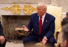 Networks Split Over Trump’s Primetime Election Address A man in a blue suit and red tie gesturing during a discussion in a formal setting
