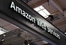 Pentagon’s AI Push Gains Powerful Partner Sign displaying Amazon Web Services at a trade show