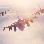 Another Airspace Breach Brings NORAD Into Action Three fighter jets flying in formation above clouds at sunrise