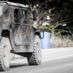Military vehicle driving on a rural road