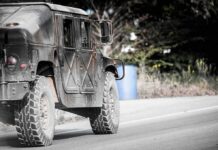 Military vehicle driving on a rural road