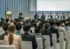 Audience listening to a panel discussion in a conference hall