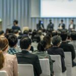 Audience listening to a panel discussion in a conference hall