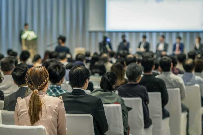 Audience listening to a panel discussion in a conference hall