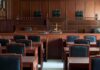 Empty courtroom with wooden benches and judge's bench