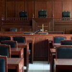 Planning Or Psychosis? Jurors Face Haunting Question Empty courtroom with wooden benches and judge's bench