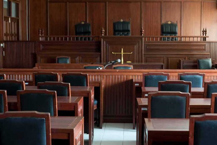 Empty courtroom with wooden benches and judge's bench
