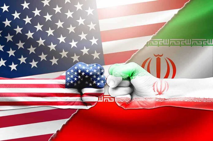 shutterstock_1612162021 US and Iran flag fists bumping against split flags