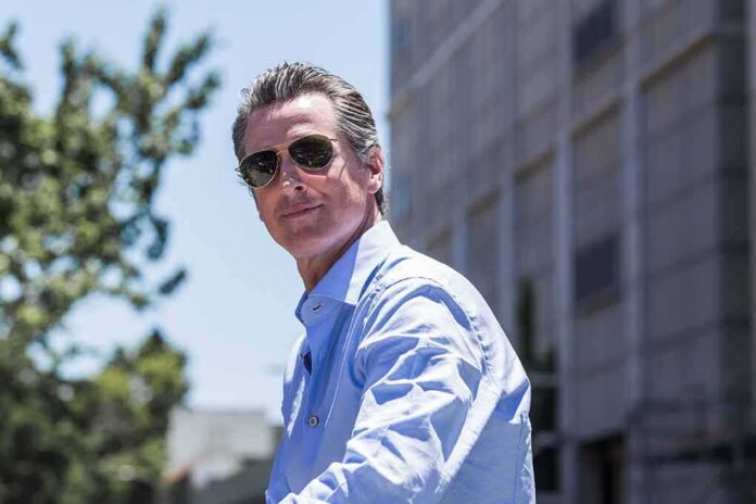 shutterstock_1677676426 man in sunglasses wearing a light blue shirt outdoors
