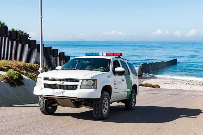 Border patrol SUV parked near beach fence