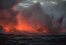 Summit Stirring: New Vents, Hotter Clues Volcanic steam plume over dark ocean at dusk