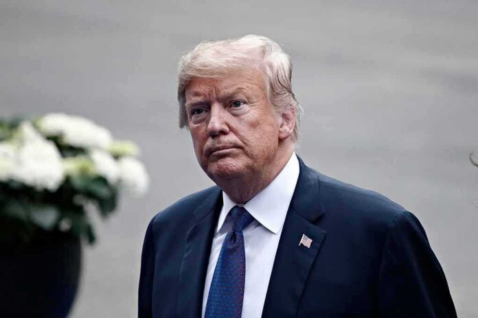man in a suit with an American flag pin
